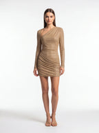 Woman wearing a beige long-sleeve dress on a white background