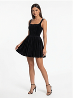 Woman wearing a black dress on a white background