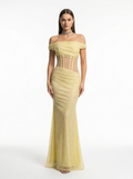 Woman wearing a yellow off-shoulder dress on a white background