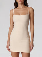 Beige dress worn by a model on a plain background