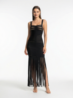 Black fringe dress worn by a model on a white background