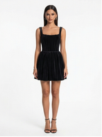 Woman wearing a black dress on a white background