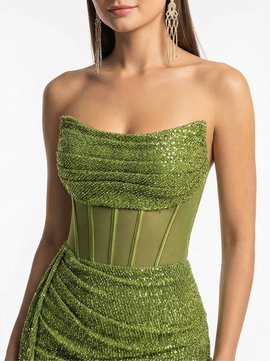 Green strapless dress with sequin detailing on a white background