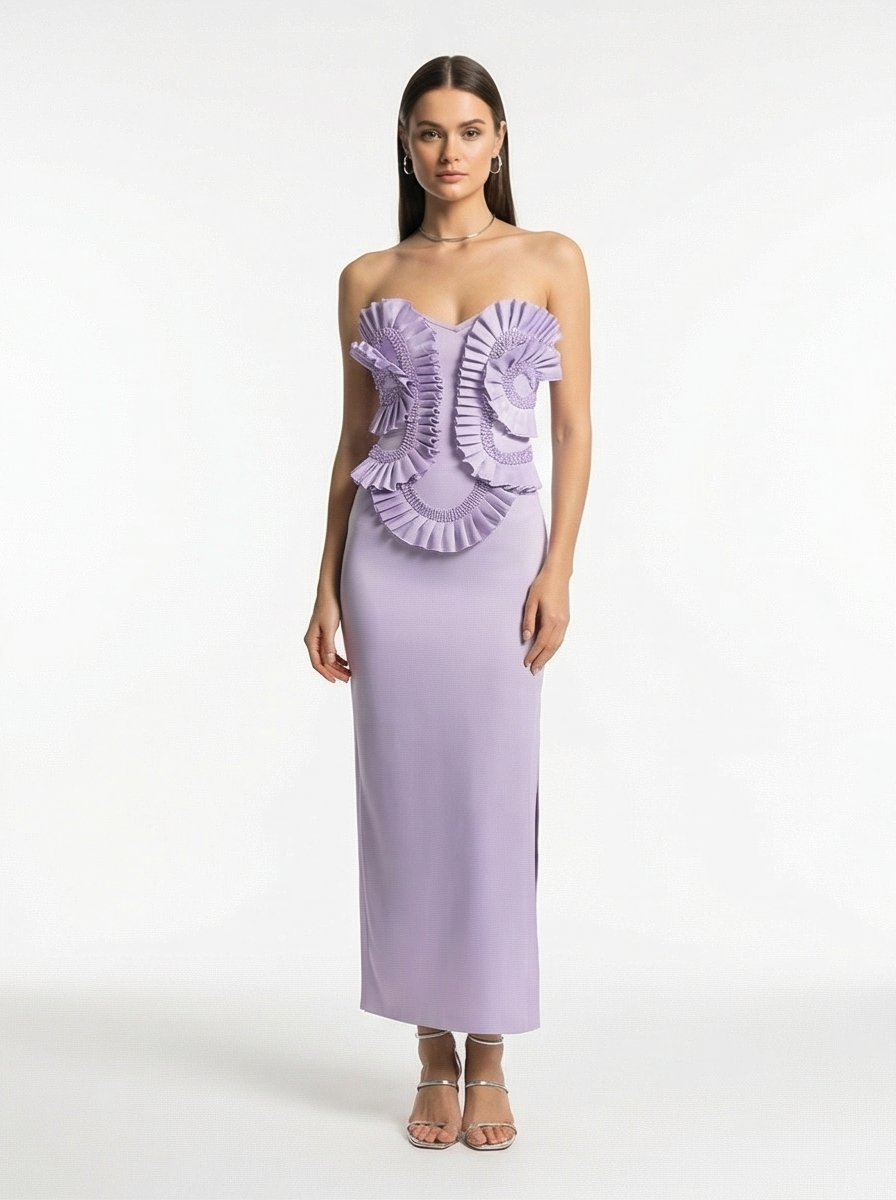 Woman wearing a strapless lavender gown with ruffled top on a white background