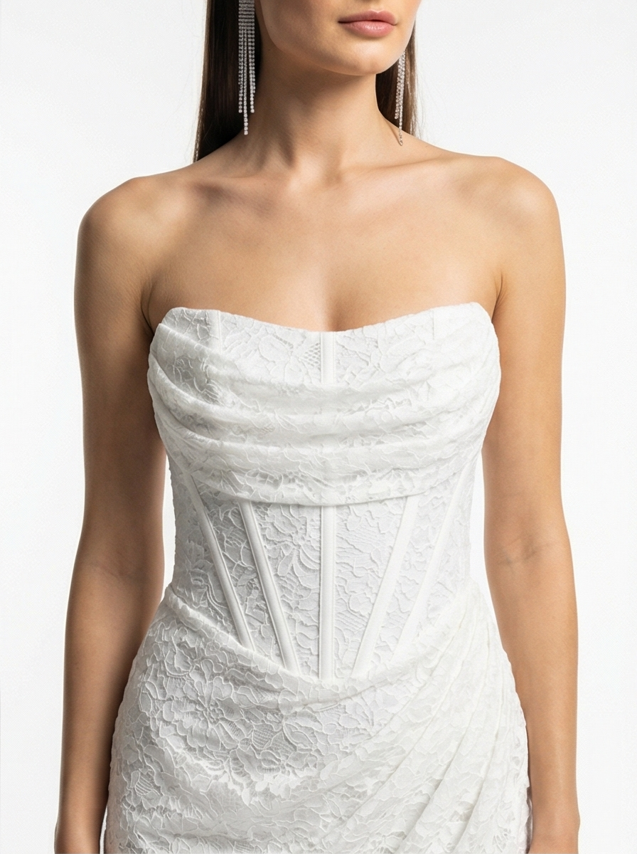White strapless lace dress on a model against a white background